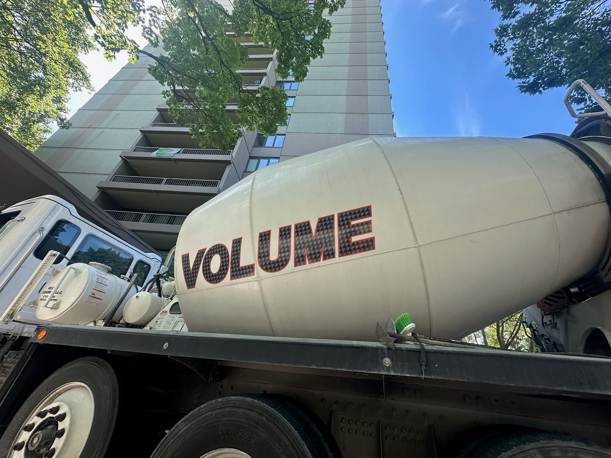 Close-up of a white Volume Concrete barrel drum with VOLUME branding