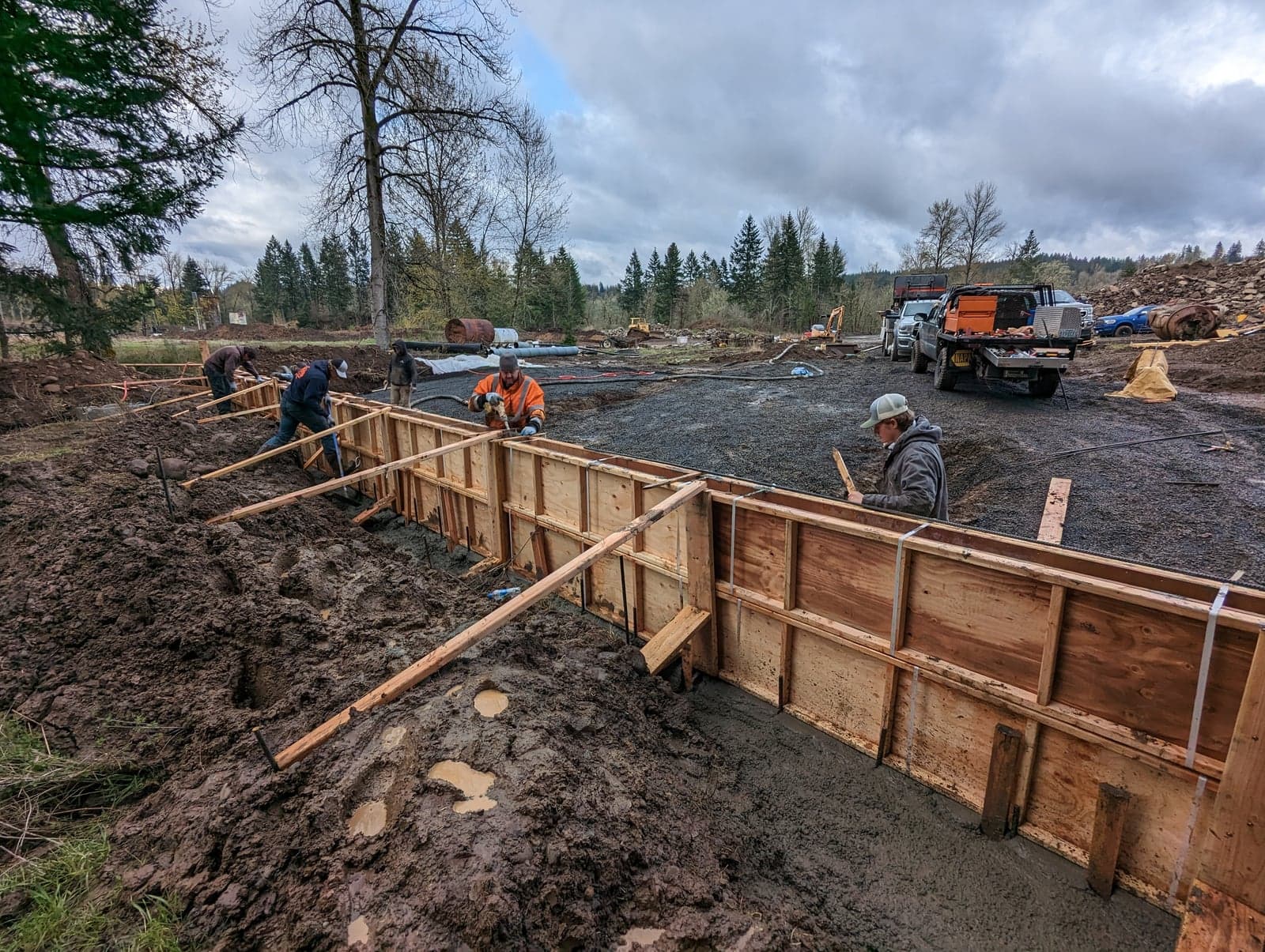 Pump hose placing concrete into wooden forms